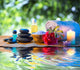 stones, candle camellia oil salt towel on water Wall Mural