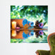 two candles and towels black stones and purple daisy on water Wall Mural