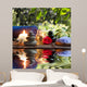 candles, towels, stones and almond flowers in water Wall Mural