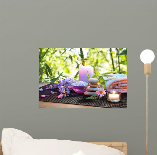 massage in the bamboo garden with violet flowers, candles Wall Mural
