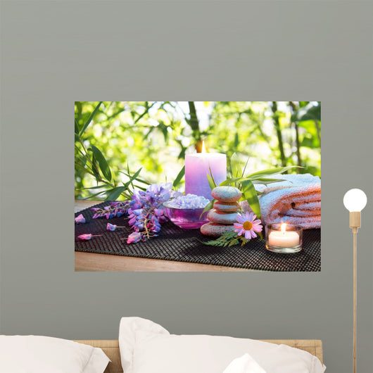 massage in the bamboo garden with violet flowers, candles Wall Mural