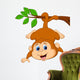 Cute monkey hanging on a tree branch Wall Decal