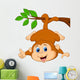 Cute monkey hanging on a tree branch with thumb up Wall Decal