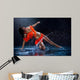 Woman dancing under rain in orange dress. Studio Wall Mural