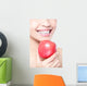 young woman eating red apple with health teeth Wall Mural