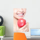 young woman eating red apple with health teeth Wall Mural