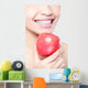 young woman eating red apple with health teeth Wall Mural