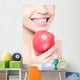 young woman eating red apple with health teeth Wall Mural