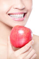 young woman eating red apple with health teeth Wall Mural