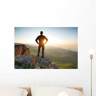 Man Top Mountain shown on a wall