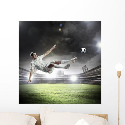 Football Player Striking Ball shown on a wall