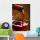 Wine pours into the glass of the bottle Wall Mural