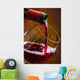 Wine pours into the glass of the bottle Wall Mural