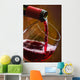 Wine pours into the glass of the bottle Wall Mural