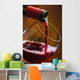 Wine pours into the glass of the bottle Wall Mural