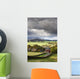 Grass fields and autumn coloured trees under storm clouds Wall Mural