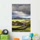 Grass fields and autumn coloured trees under storm clouds Wall Mural