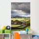 Grass fields and autumn coloured trees under storm clouds Wall Mural