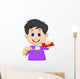 Kid squeezing tooth paste on a toothbrush Wall Decal
