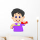 Kid squeezing tooth paste on a toothbrush Wall Decal