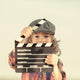 Kid Holding Clapper Board