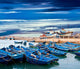 Blue fishing boats on an ocean coast in Essaouira, Morocco Wall Mural