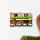 Cafe tables and chairs outside a stone building in Tuscany Wall Mural
