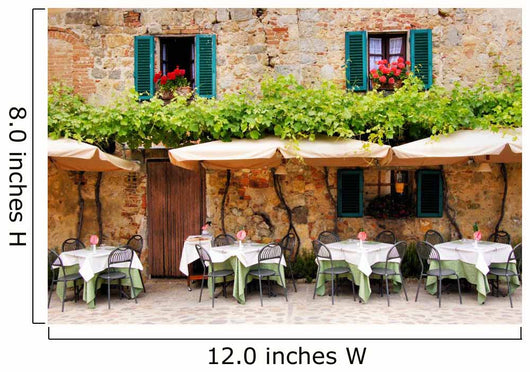 Cafe tables and chairs outside a stone building in Tuscany Wall Mural