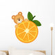 Teddy bear eating orange slice Wall Decal