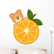 Teddy bear eating orange slice Wall Decal