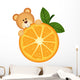 Teddy bear eating orange slice Wall Decal