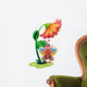 A butterfly waving below the giant flower Wall Decal