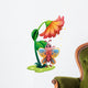 A butterfly waving below the giant flower Wall Decal