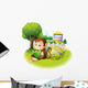 A monkey reading a book near the plants with flowers Wall Decal