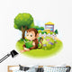 A monkey reading a book near the plants with flowers Wall Decal
