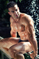 Muscular Wet Bodybuilder Sitting on Railing Wall Mural