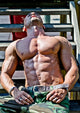 Muscular Bodybuilder Laying Wood