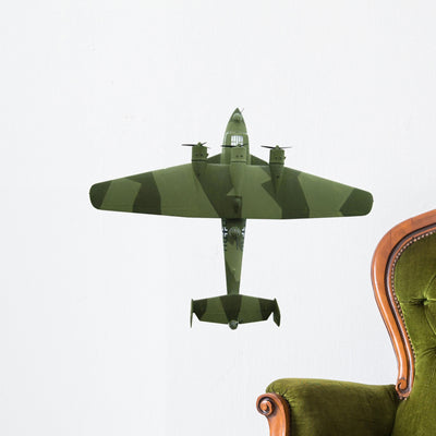 Toy Green Military Airplane Wall Decal shown on a wall