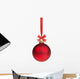 red christmas ball hanging on ribbon with bow 