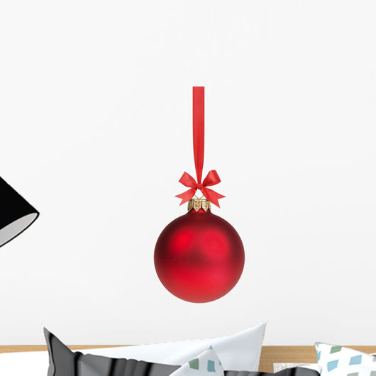 red christmas ball hanging on ribbon with bow 