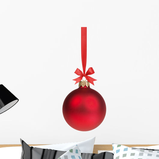 red christmas ball hanging on ribbon with bow 