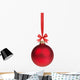 red christmas ball hanging on ribbon with bow 