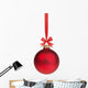 red christmas ball hanging on ribbon with bow 