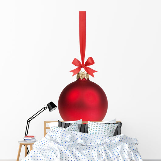 red christmas ball hanging on ribbon with bow 