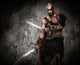 Wounded gladiator with two swords covered in blood 