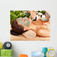 Woman having clay facial mask apply by beautician. 