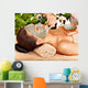 Woman having clay facial mask apply by beautician. 