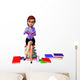 Young girl sitting on the pile of books Wall Decal