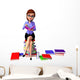 Young girl sitting on the pile of books Wall Decal