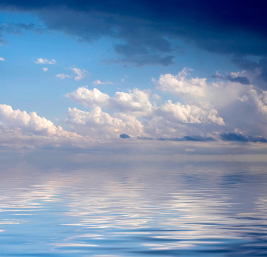 Blue dramatic sky over water Wall Mural